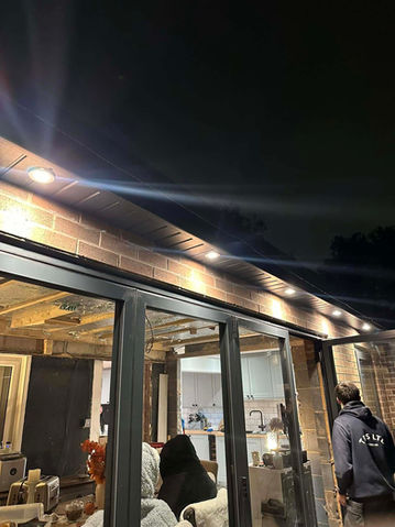 Night scene of a restaurant with lights and windows at night.