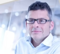 Headshot of a man wearing glasses