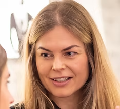 Woman smiling, engaging in conversation