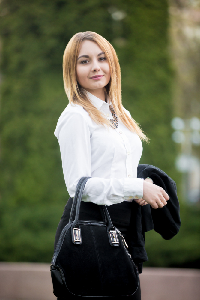 Woman in white shirt and black handbag