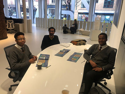 Three men sit at a table, discussing documents, Future Frontiers