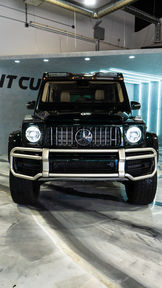 Black Mercedes-Benz G-Wagen front with "NT CU" text background.