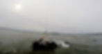 Person kitesurfing in choppy water