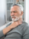 Elderly man in pain, grasping his sore throat, suffering visible discomfort.