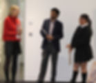Three people in discussion, standing; Harleen's Story visible, speaking together.