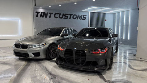 Grey and black BMW M cars at TINT CUSTOMS detail shop.