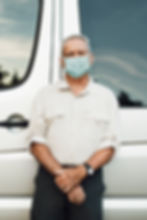 senior-man-standing-by-camper-van-new-normal.jpg