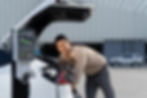 young-man-put-ev-charger-recharge-electric-car-s-battery-from-charging-station-city-commer