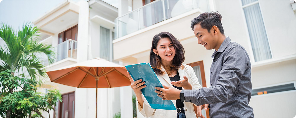 Couple reviewing house plans with realtor