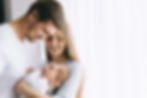cheerful-family-carrying-little-baby-boy-in-front--9AX4TXW.jpg
