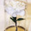 Thumbnail: Handsewn floral in a glass bell jar on a weighted gold mirrored base