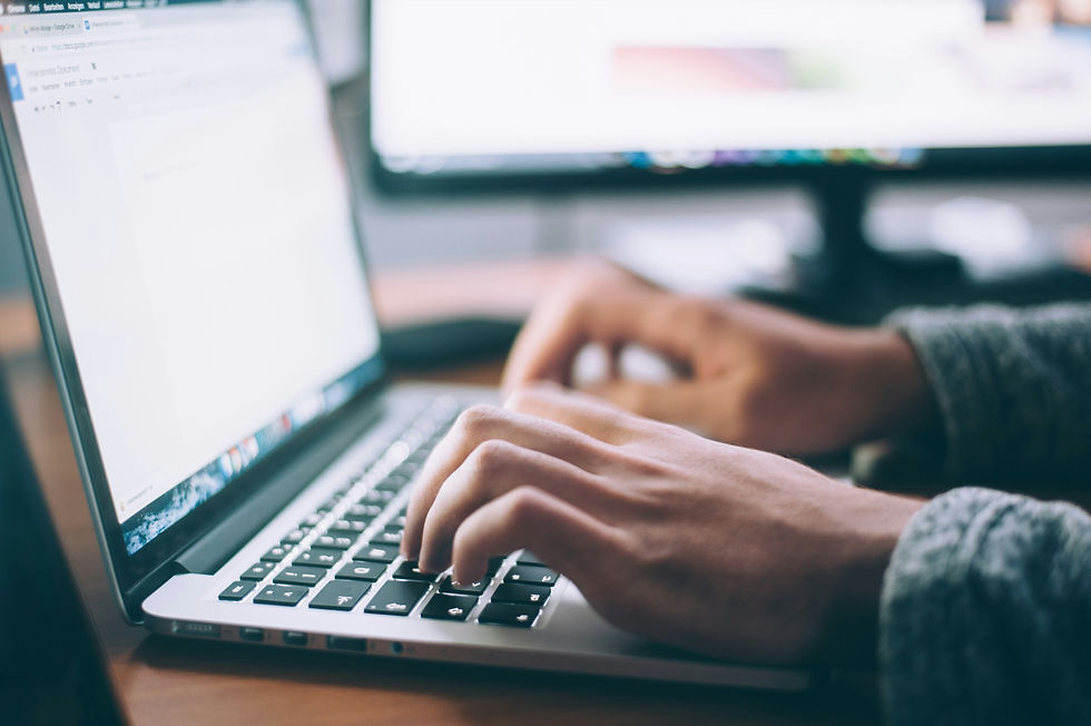 Close up of person's hands typing on laptop
