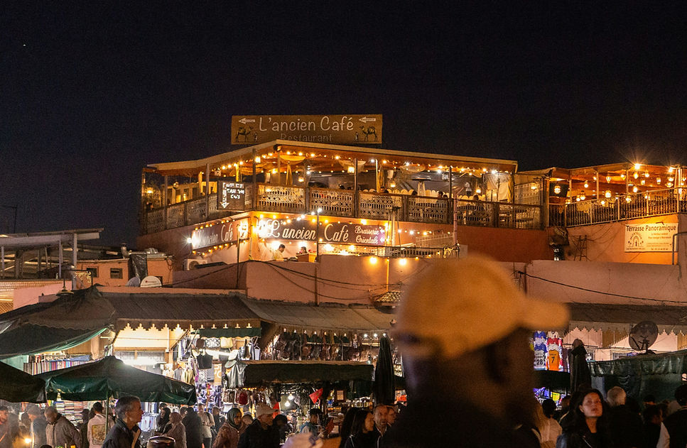 A crowd of people standing around a market at night_edited.jpg