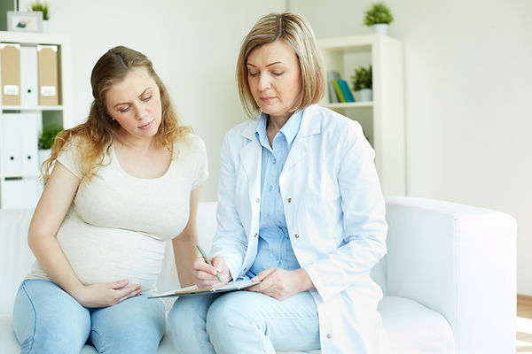 pregnant-woman-talking-her-doctor-room.jpg