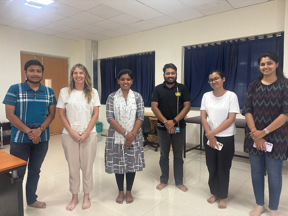Six people standing in a row, smiling at the camera
