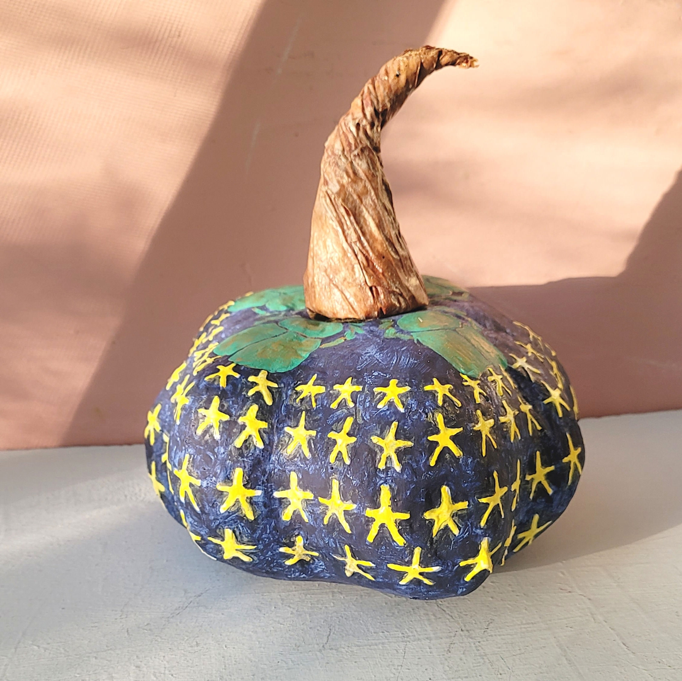blue and yellow paper mache Egyptian inspired glow in the dark pumpkin