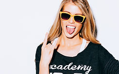 Lovely young blond woman making a call me gesture and showing tongue in suglasses, Sweatsh