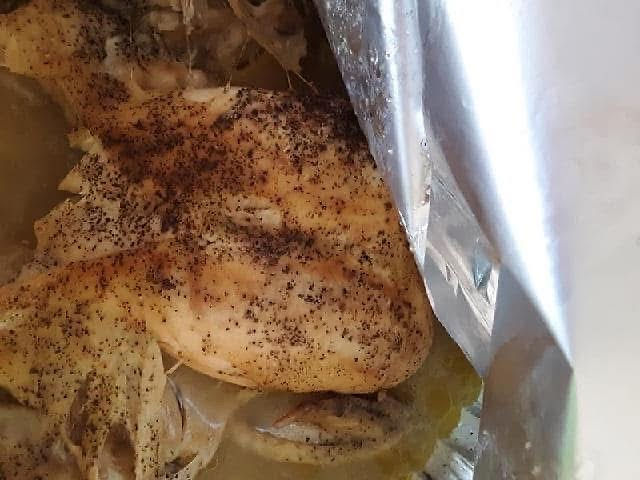 Seasoned chicken cooking in a bag