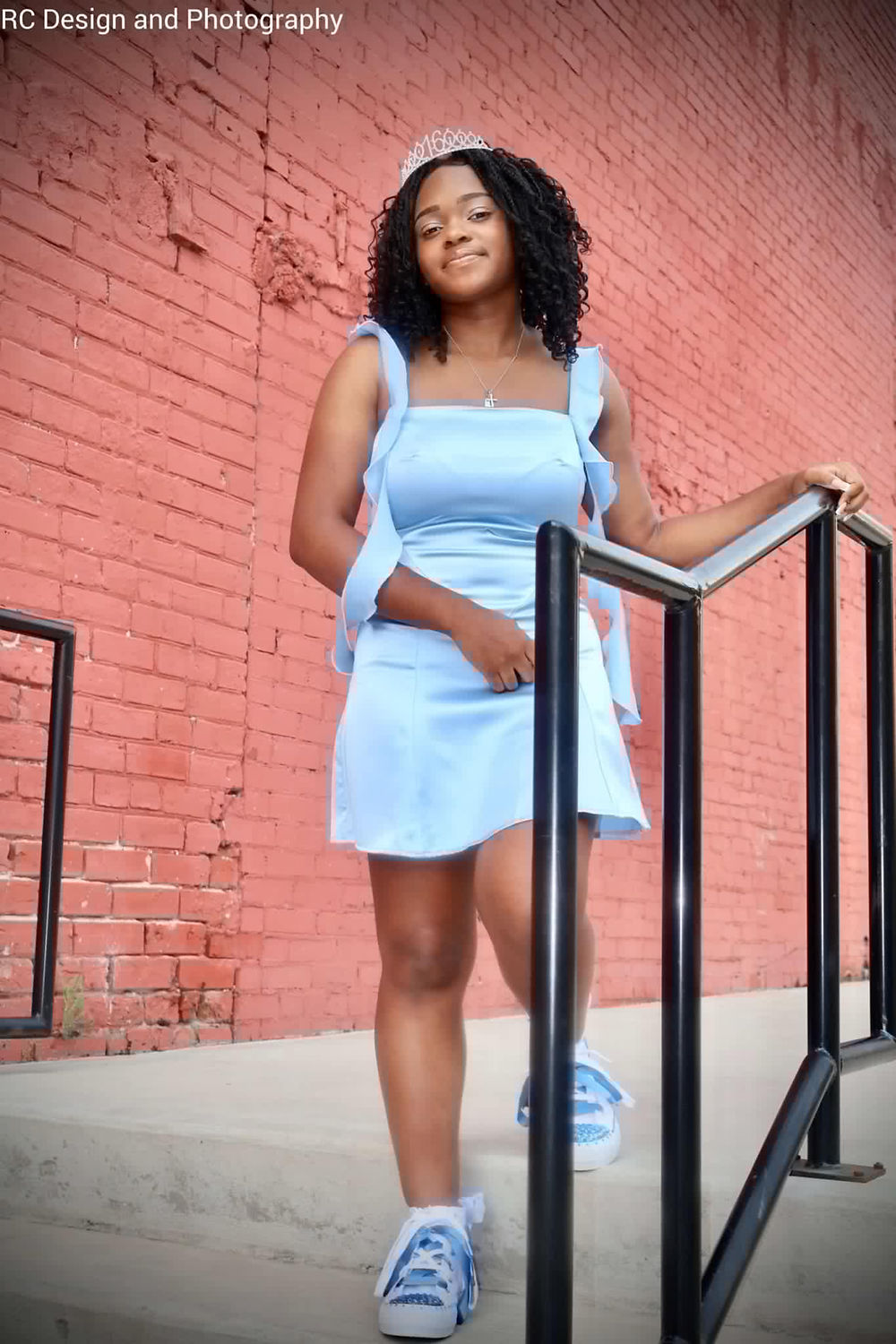 Young woman in light blue dress on stairs