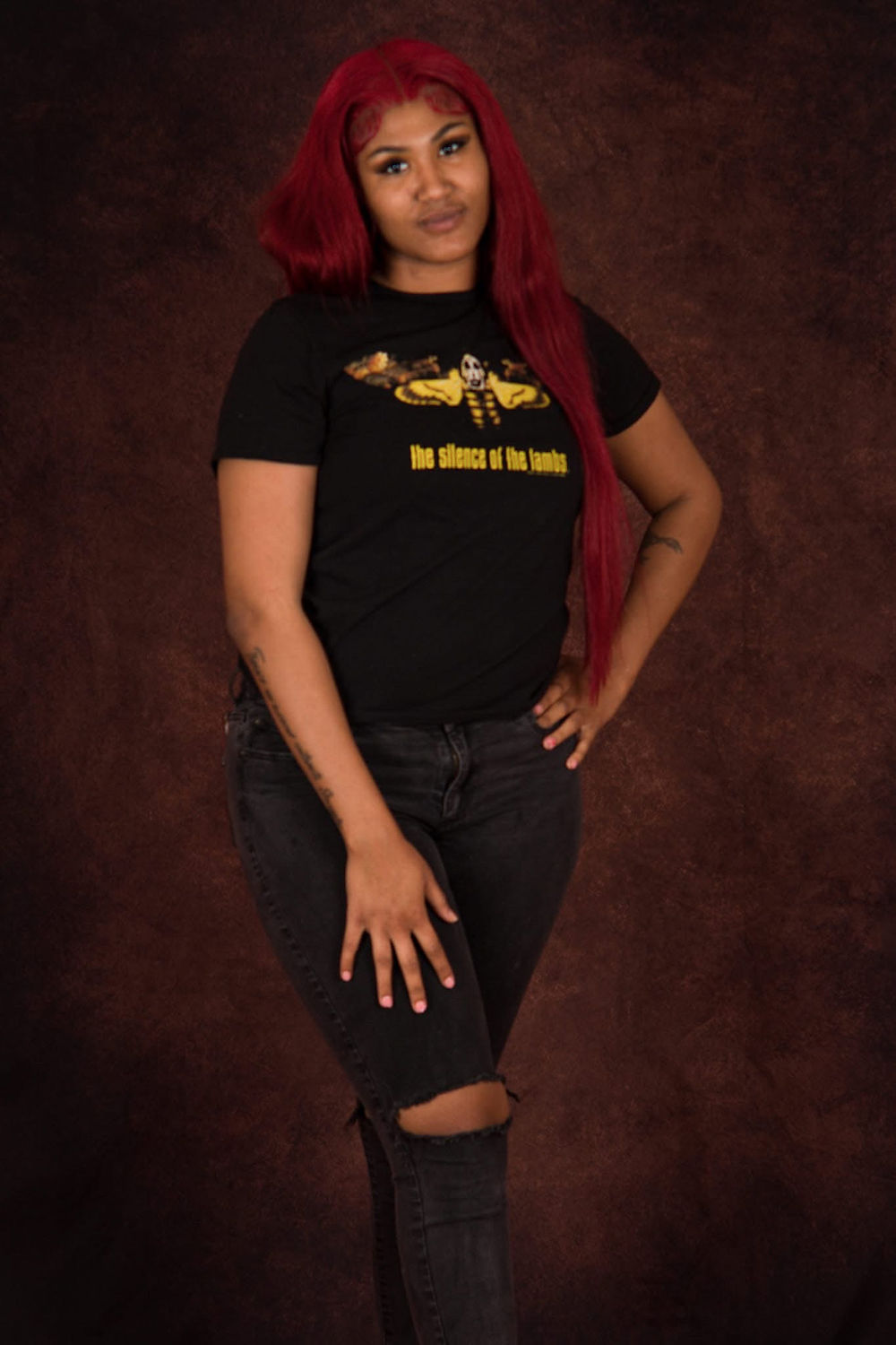 Woman with red hair and 'THE RIDDLE OF THE BATMAN' t-shirt