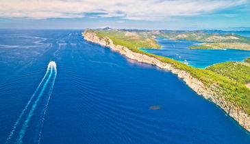 Aerial view of Kornati islands with luxury boat navigating between them