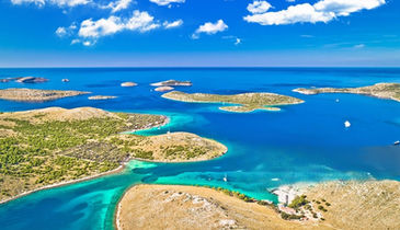 Wide panoramic view of Kornati islands with luxury boat