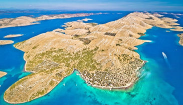 Luxury boat cruising between dry rocky islands of Kornati