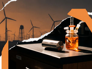 Torn-paper photographic montage of a laboratory bench with a glowing orange reaction vessel and metal cylinder against a skyline of wind turbines and water towers at sunset