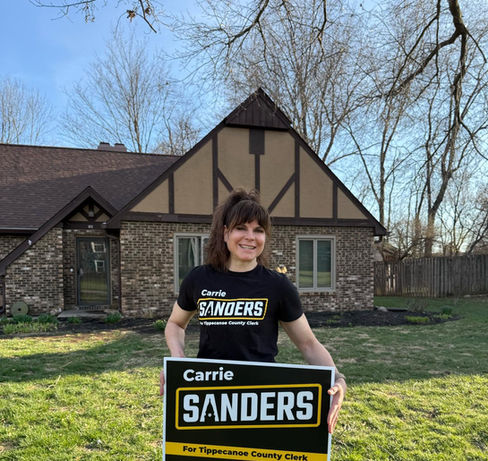 Carrie Sanders with Yard Sign
