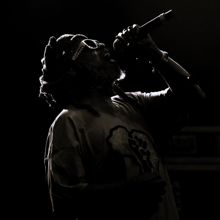 Silhouette d'artiste chantant avec microphone. En concert, ambiance sombre, JRP photographe.