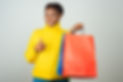 cheerful-satisfied-customer-holding-shop