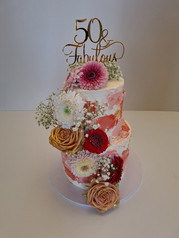 Festive 50th birthday cake with gold accents and ‘Happy 50th Birthday’ message, crafted by Stentons Cakes on the Gold Coast.