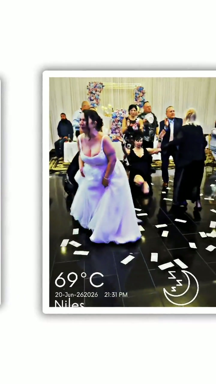 Bride dancing with guests on a dark dance floor under a white draped ceiling