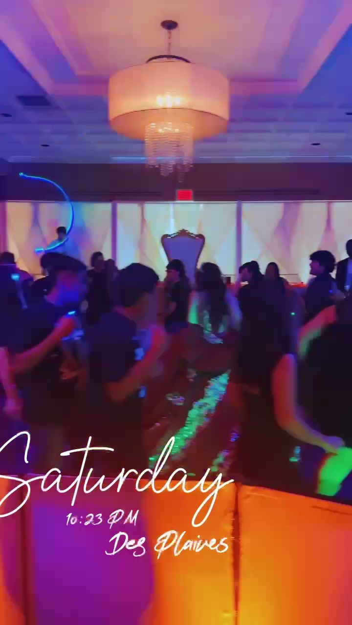 Quinceañera dance floor seen from the DJ booth, crowd dancing under colored lights