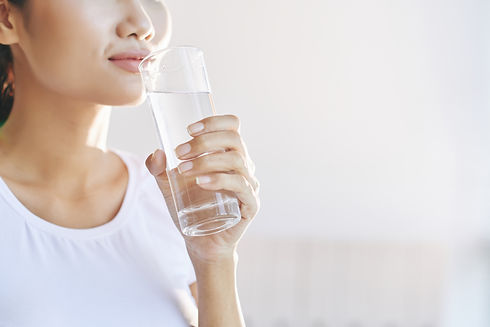 unrecognizable-woman-carrying-glass-water-mouth.jpg