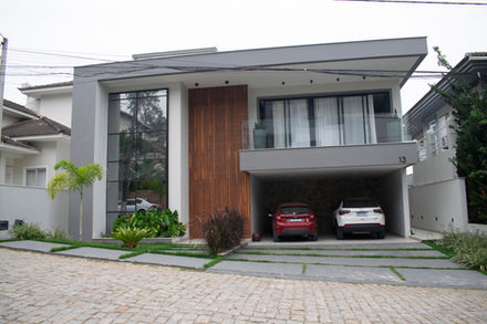 Casa moderna de dois andares com design contemporâneo. Fachada de madeira e pedra. Dois carros estaciona
