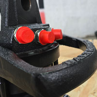 Close-up of black metallic object with red caps and metallic fasteners