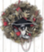 Handcrafted Gasparilla pirate wreath featuring bold skull details and rich black, gold, and red ribbon.