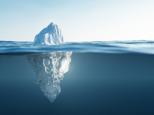 An Ice berg half-submerged in the ocean representing the hidden costs within testing