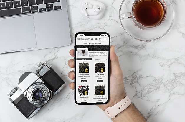 mockup-of-a-photographer-holding-an-iphone-12-pro-max-over-his-desk-m21884.png