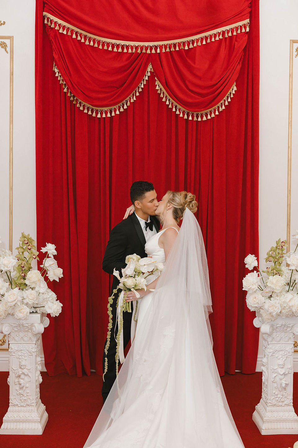 beautiful picture of the newlyweds kissing after their ceremony