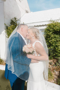 picture of the groom kissing the bride on the cheek