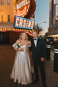 cute picture of the newlyweds showing their wedding rings