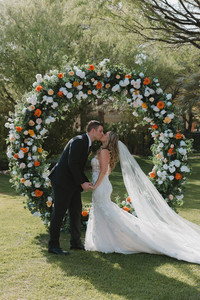 bride and groom kissing after their wedding ceremony