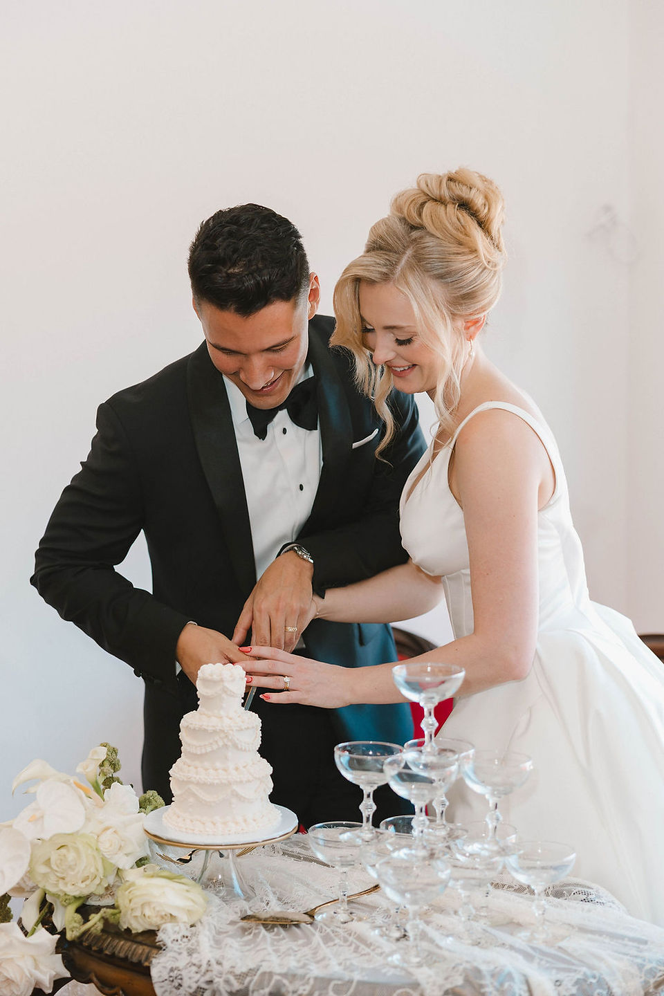 cute picture of the newlyweds cutting their wedding cake