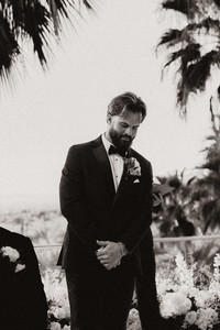 groom watching the bride walk down the aisle