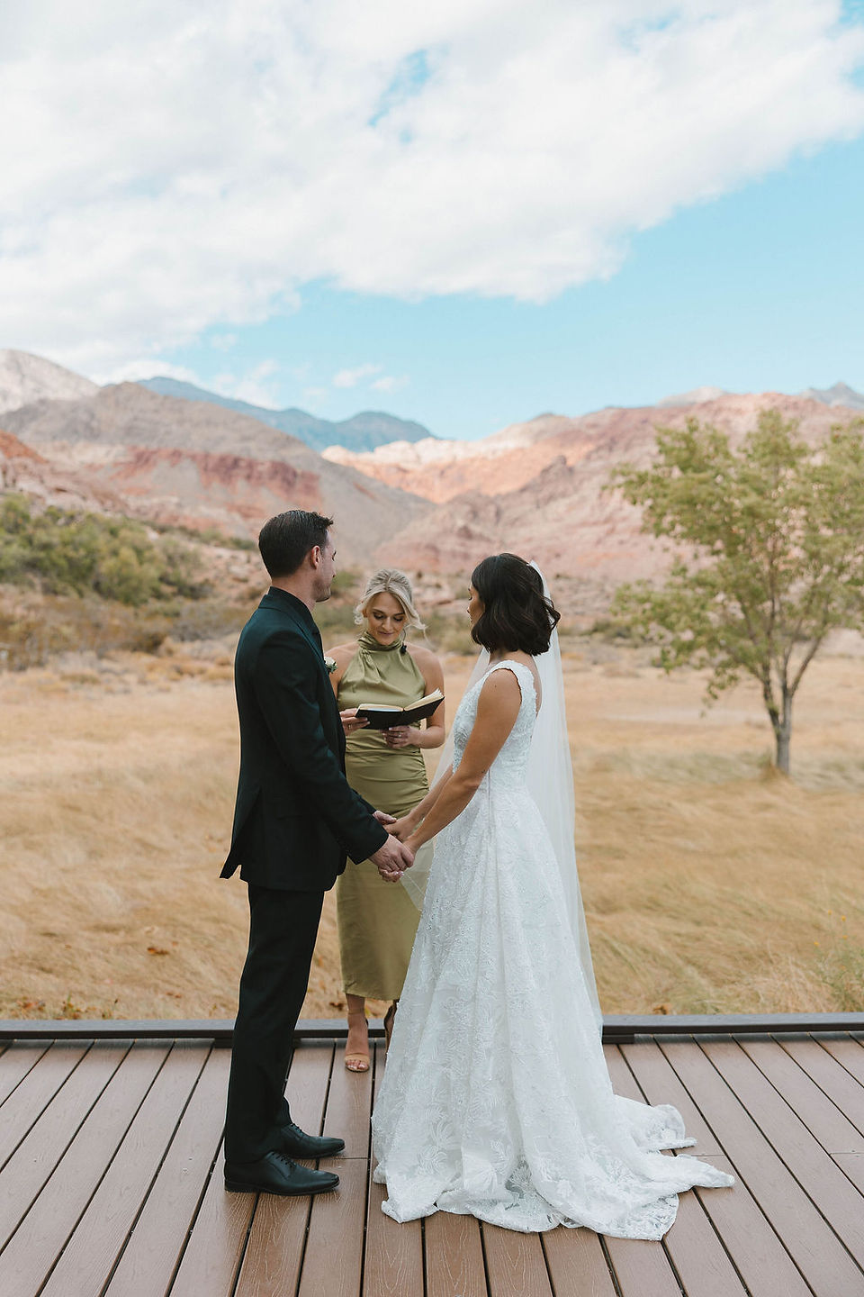 bride and groom holding hands during their ceremony