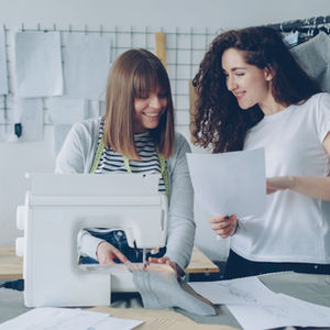 Small Business - stylish fashion design studio with sewing machine and sketches.
