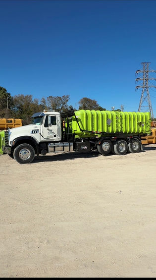 White dump truck with bright green bed