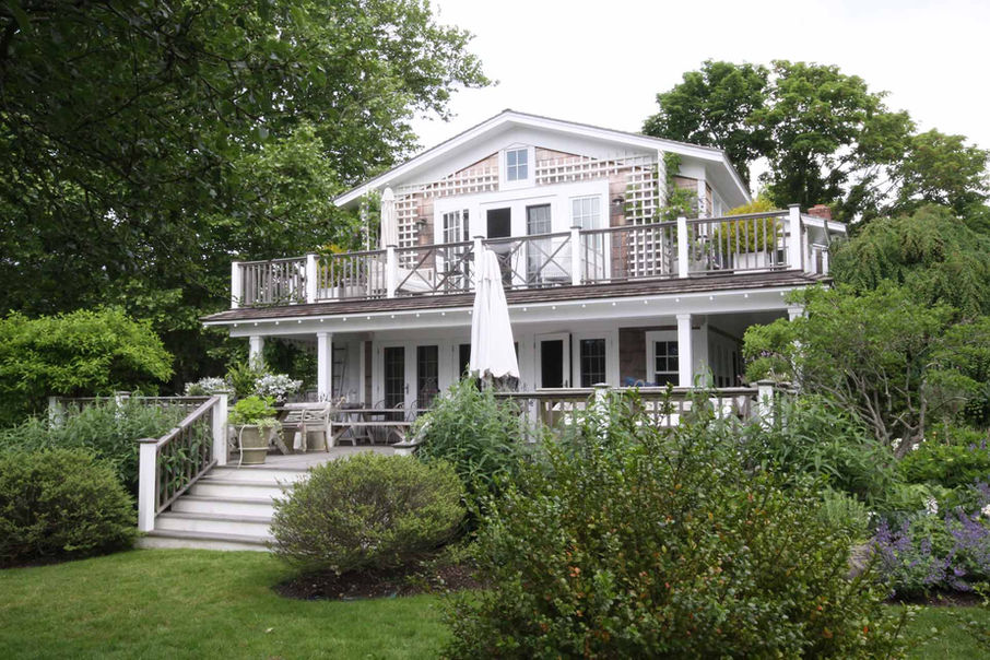 Mecox Road view of front of house showing entrance and first floor balcony. Pamela Glazer Architecture